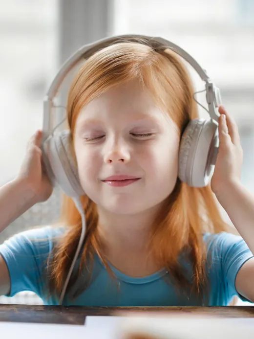 Kulaklıkla müzik dinleyen, gözleri kapalı çocuk